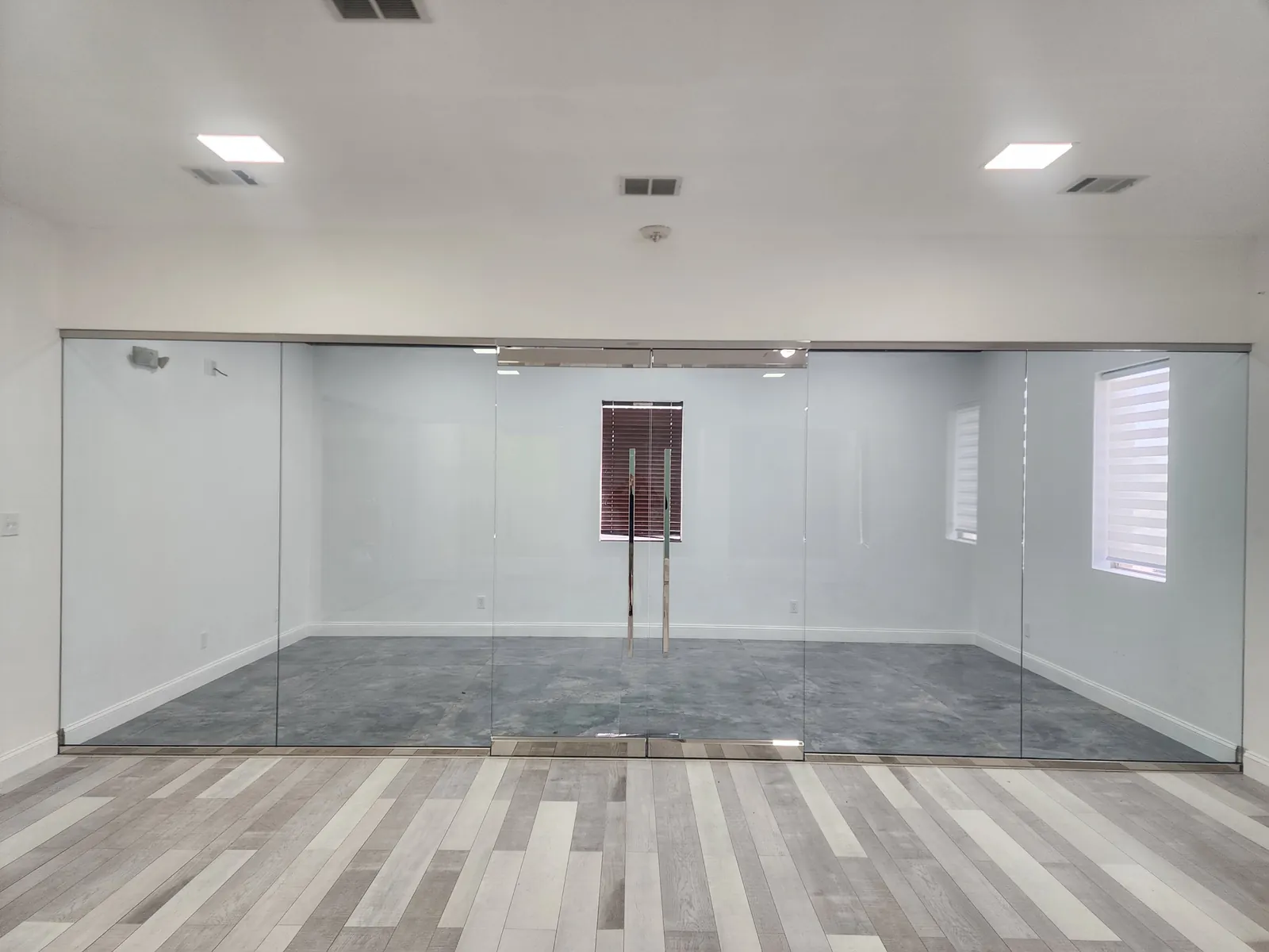 Frameless glass office front with a center glass door
